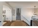 Entry hall with dark stairs and a chandelier hanging over the front door at 210 Barrett Springs Way, Canton, GA 30115