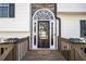 Close-up of a beautiful front door with decorative glass and stone accents, enhancing its curb appeal at 210 Barrett Springs Way, Canton, GA 30115