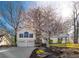 Charming two-story home featuring a well-manicured lawn and flowering tree, enhancing its curb appeal at 210 Barrett Springs Way, Canton, GA 30115