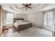 Inviting main bedroom featuring a decorative ceiling fan, a rustic bedframe, and natural light at 210 Barrett Springs Way, Canton, GA 30115