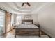 Charming main bedroom with a tray ceiling, a rustic bedframe, and soft natural lighting at 210 Barrett Springs Way, Canton, GA 30115