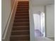 Carpeted staircase leading to the upper level, with a view of the hallway and arched entryway at 2102 Executive Dr, Duluth, GA 30096