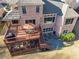Aerial view of brick home with multiple decks, outdoor seating, and a well-maintained yard at 7085 Wakehurst Pl, Cumming, GA 30040