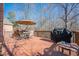 Outdoor deck complete with dining set, grill, and an umbrella table at 7085 Wakehurst Pl, Cumming, GA 30040