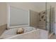Bathroom featuring a soaking tub, separate glass shower, and window with blinds at 7085 Wakehurst Pl, Cumming, GA 30040