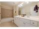 Bathroom with double sink vanity, tile floor, and shower/tub combo at 7085 Wakehurst Pl, Cumming, GA 30040