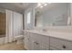 Bright bathroom with large vanity and walk-in shower behind the curtain at 7085 Wakehurst Pl, Cumming, GA 30040