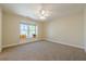 Bright bedroom with a large window seat and neutral carpet at 7085 Wakehurst Pl, Cumming, GA 30040