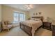 Cozy bedroom with hardwood floors, natural light, and dark wood accents at 7085 Wakehurst Pl, Cumming, GA 30040