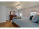 Bedroom with hardwood floors, dresser, and bright natural light at 7085 Wakehurst Pl, Cumming, GA 30040