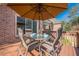 Outdoor table with seating on the upper level deck of a brick home at 7085 Wakehurst Pl, Cumming, GA 30040