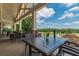 Outdoor patio seating with views of the lake and golf course at 7085 Wakehurst Pl, Cumming, GA 30040