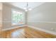 Formal dining room with hardwood floors and a large window overlooking the deck at 7085 Wakehurst Pl, Cumming, GA 30040