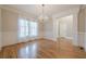 Formal dining room featuring hardwood floors, a chandelier, and wainscoting at 7085 Wakehurst Pl, Cumming, GA 30040