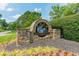 Stone entrance sign for Polo Golf & Country Club with well-manicured landscaping at 7085 Wakehurst Pl, Cumming, GA 30040