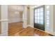Inviting entryway features hardwood floors and opens to a dining area with a crystal chandelier at 7085 Wakehurst Pl, Cumming, GA 30040