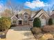 Charming brick home with a manicured lawn, a two car garage, and well-maintained landscaping at 7085 Wakehurst Pl, Cumming, GA 30040