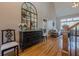 Entryway with hardwood floors, a large mirror, console table, and a glimpse of the living room at 7085 Wakehurst Pl, Cumming, GA 30040