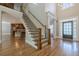 Grand foyer with staircase, hardwood floors, and a welcoming entrance at 7085 Wakehurst Pl, Cumming, GA 30040