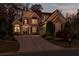 Charming two-story brick home with manicured lawn and a long driveway at 7085 Wakehurst Pl, Cumming, GA 30040