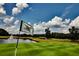 Scenic golf course view, showcasing lush green fairways, a tranquil pond, and the course's well-manicured landscape at 7085 Wakehurst Pl, Cumming, GA 30040