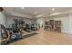Finished basement with home gym equipment, a TV area, and built-in bookshelves at 7085 Wakehurst Pl, Cumming, GA 30040