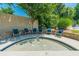 Outdoor hot tub with seating surrounded by stone and lush greenery, providing a relaxing retreat at 7085 Wakehurst Pl, Cumming, GA 30040