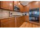 Close up of a kitchen showcasing stainless steel microwave, oven, and cooktop at 7085 Wakehurst Pl, Cumming, GA 30040