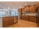 Modern kitchen with stainless steel appliances, wooden cabinetry and granite countertops at 7085 Wakehurst Pl, Cumming, GA 30040