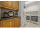 Well-organized laundry room with ample storage cabinets and granite countertops at 7085 Wakehurst Pl, Cumming, GA 30040