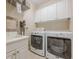 Clean and bright laundry room equipped with modern washer and dryer machines at 7085 Wakehurst Pl, Cumming, GA 30040