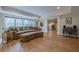 Spacious living room with hardwood floors, comfortable seating, and large windows for natural light at 7085 Wakehurst Pl, Cumming, GA 30040