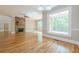 Bright living room featuring a stone fireplace and large windows to the outside deck at 7085 Wakehurst Pl, Cumming, GA 30040