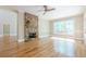 Bright open-concept living room with stone fireplace and views of outdoor living at 7085 Wakehurst Pl, Cumming, GA 30040