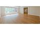 Open-concept living area featuring hardwood floors, large windows and an entryway at 7085 Wakehurst Pl, Cumming, GA 30040