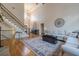 Spacious living room with high ceilings, staircase, hardwood floors, and stylish decor at 7085 Wakehurst Pl, Cumming, GA 30040