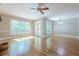 Spacious living room area with floor-to-ceiling windows and access to an outdoor deck at 7085 Wakehurst Pl, Cumming, GA 30040