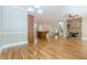 Open concept living and kitchen area, featuring hardwood floors and stone fireplace at 7085 Wakehurst Pl, Cumming, GA 30040