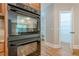 Modern oven with stainless steel accents, connecting the kitchen and bathroom area at 7085 Wakehurst Pl, Cumming, GA 30040