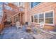 Outdoor patio area with brick walls, a fire pit, and ample seating for entertaining at 7085 Wakehurst Pl, Cumming, GA 30040