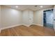 Finished room features durable laminate flooring, ample lighting, and a neutral color palette at 7085 Wakehurst Pl, Cumming, GA 30040