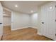 Bright, finished room with laminate flooring offering versatility for a living space or bedroom at 7085 Wakehurst Pl, Cumming, GA 30040