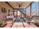 Relaxing screened porch with comfortable seating and a ceiling fan at 7085 Wakehurst Pl, Cumming, GA 30040