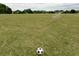 View of a well-maintained community soccer field with goals, grassy areas and soccer ball at 7085 Wakehurst Pl, Cumming, GA 30040