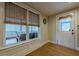 Sunroom with wood floors, a cozy seating area, and views of the outdoors at 7085 Wakehurst Pl, Cumming, GA 30040