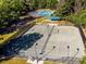 Overhead shot of a meticulously maintained tennis court, complete with regulation lines and lighting at 7085 Wakehurst Pl, Cumming, GA 30040