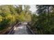 Scenic view of a paved walking path surrounded by lush greenery and trees at 7085 Wakehurst Pl, Cumming, GA 30040