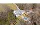 Stunning aerial view of home with in-ground pool surrounded by mature trees and a long driveway at 129 Euharlee 5 Forks Rd, Euharlee, GA 30145