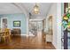 Inviting entryway with hardwood floors, an elegant chandelier, and views into the living spaces at 129 Euharlee 5 Forks Rd, Euharlee, GA 30145