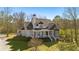 Charming two-story home with a covered front porch, white railings, and lush landscaping at 129 Euharlee 5 Forks Rd, Euharlee, GA 30145